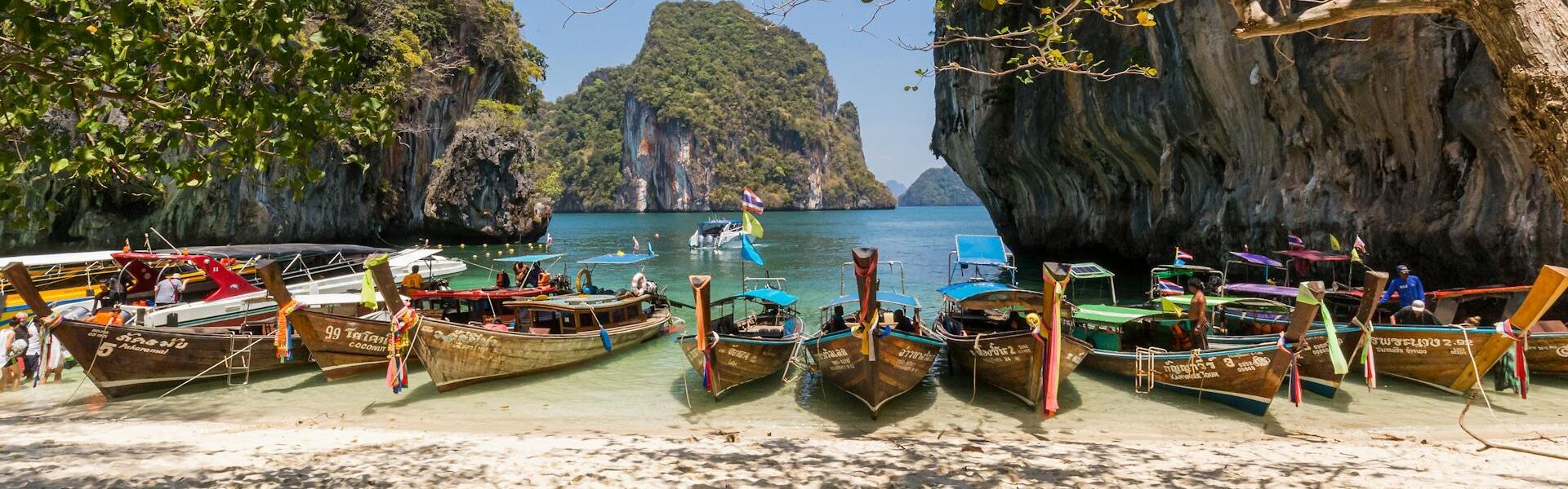 Turquoise waters of Krabi’s coastline on a scenic Krabi Travel banner by Legend Travel Group.